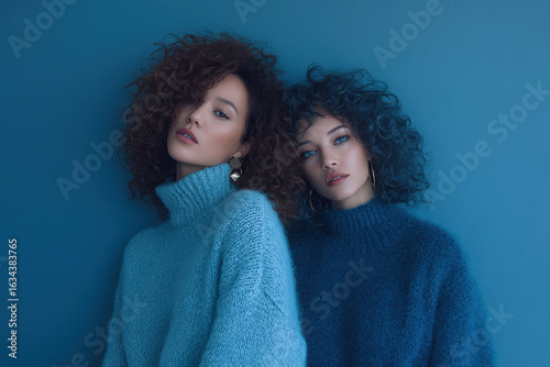 captivating portrait of matching models with unconventional hairstyles set against clean minimalistic background