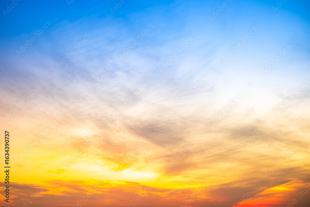Obraz premium Beautiful , luxury soft gradient orange gold clouds and sunlight on the blue sky perfect for the background, take in evening,Twilight, Large size, high definition landscape photo