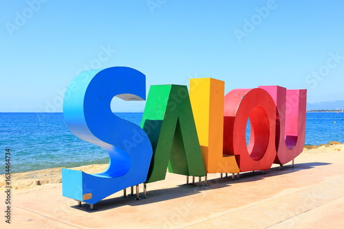 Colorful Salou name sign on the beach in Salou city, Tarragona, Spain