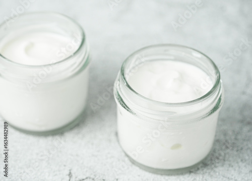Close up of Homemade Greek Yogurt in a glass jars, selective focus concept. Healthy breakfast and healthy food.