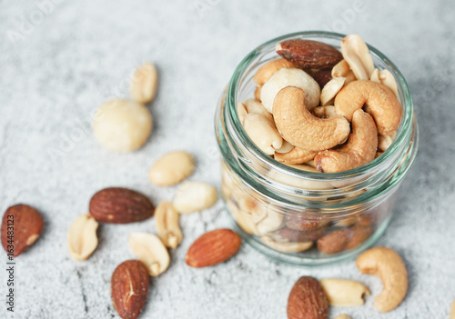Close up of Healthy mix nuts in a bowl. Almonds, hazelnuts, cashews, peanuts, pistachios and macadamia.