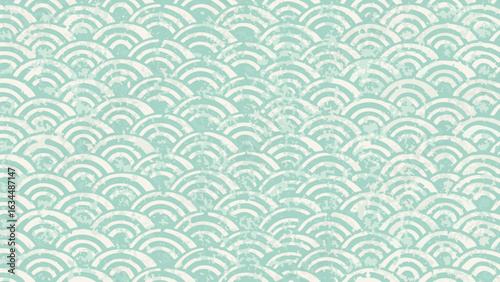 Repeating pattern of white semi circles on a light green background creating a textured wave design look