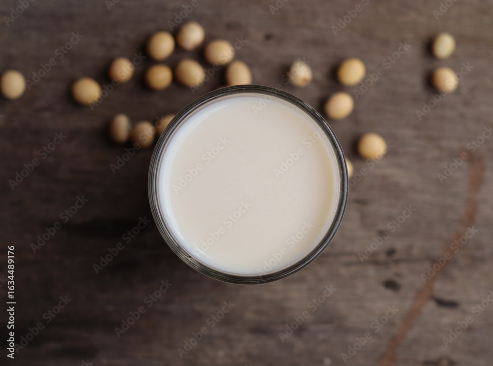 Soy milk with soybeans on wood background Soy milk with soybeans on wood background