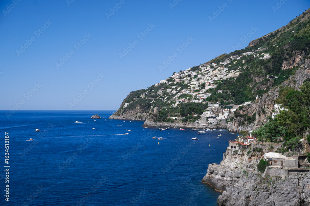 Fototapeta premium Breathtaking Cliffside Village Overlooking the Mediterranean Sea with Colorful Houses and Rugged Coastal Landscape