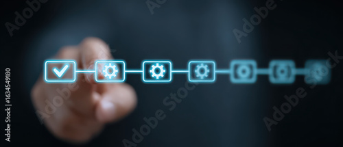 Workflow automation concept with finger pointing at glowing process icons on dark background
