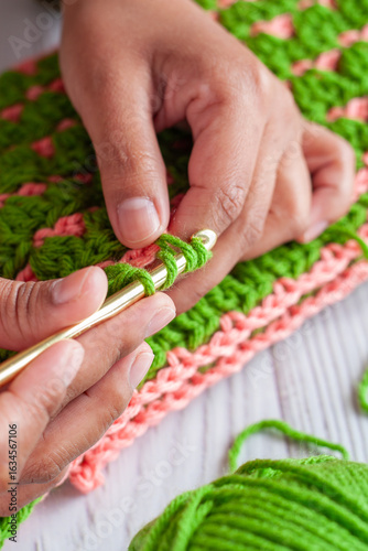 Hands of a Latin woman knitting with crochet