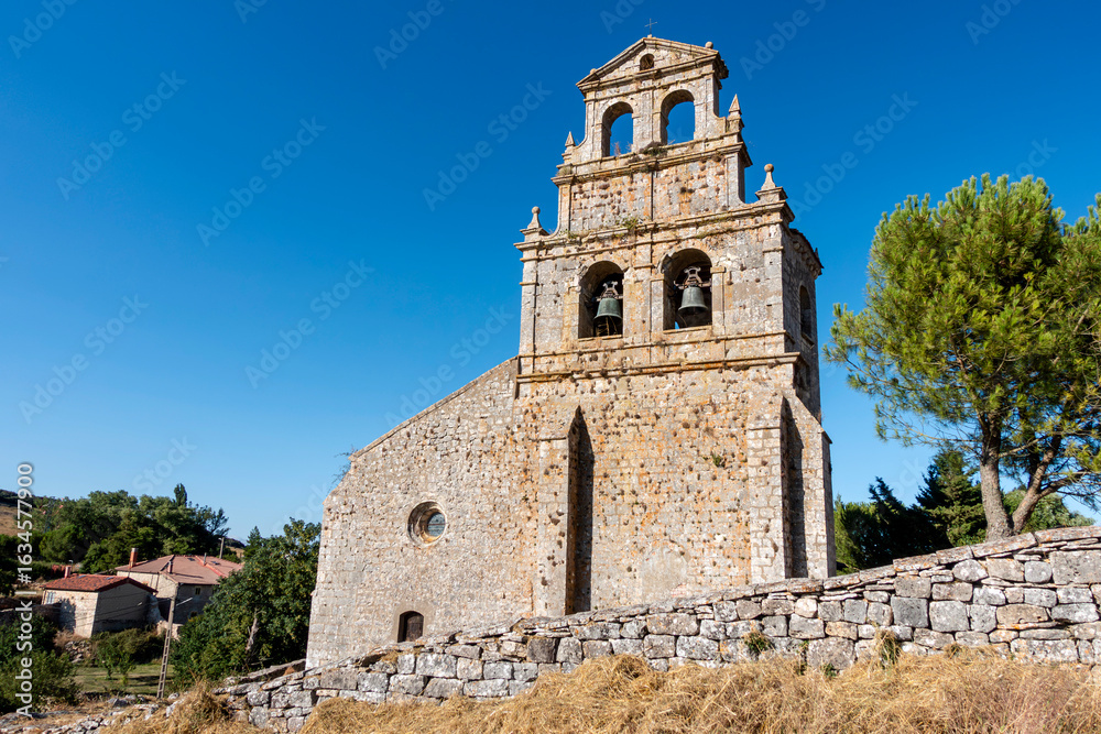 Fototapeta premium Historic church of Our Lady of the Assumption with its baroque belfry in Masa, Burgos, Spain