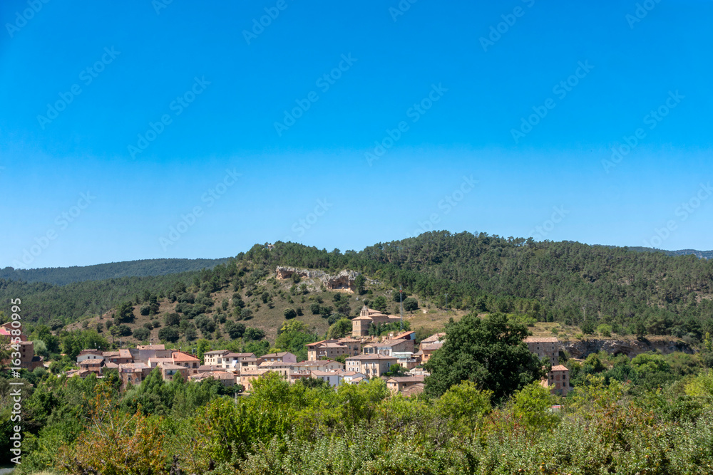 Fototapeta premium The Spanish village of Aguas Candidas nestled in a green valley, Burgos.