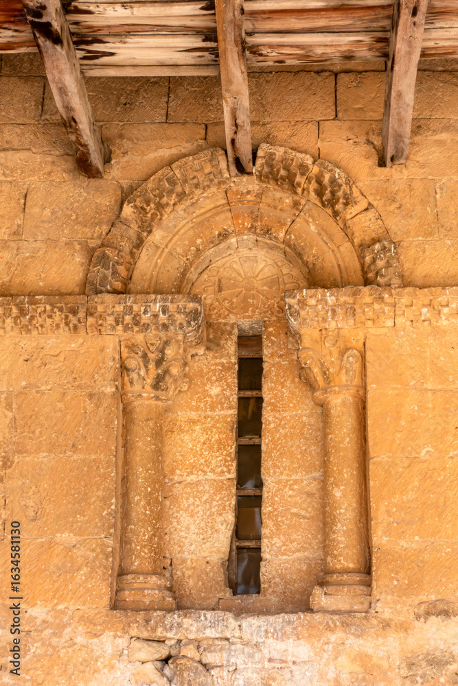Fototapeta premium Romanesque window on the facade of the Church of San Miguel, Valdenoceda de Valdivieso, Spain