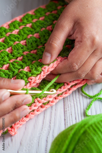 Hands of a Latin woman knitting with crochet