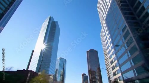 Sunlight Reflections on Glass Skyscrapers Beneath Clear Blue Sky