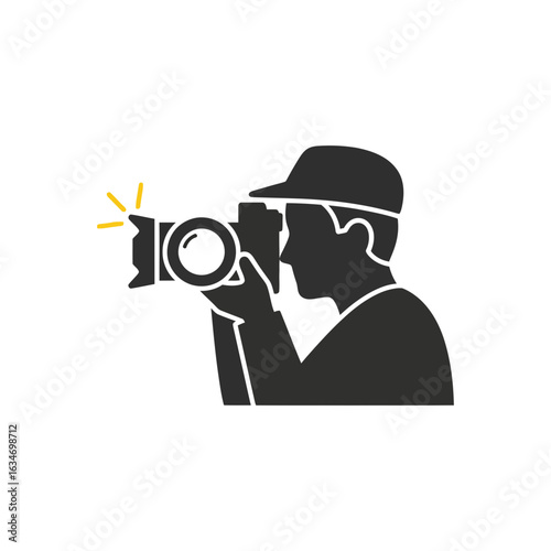 Silhouette of person wearing cap taking picture with camera and flash.