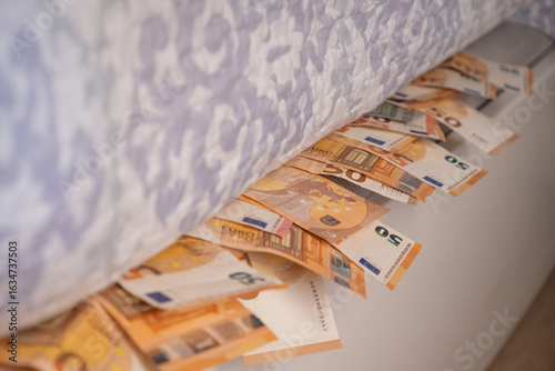Fotografie Euro banknotes hidden under mattress