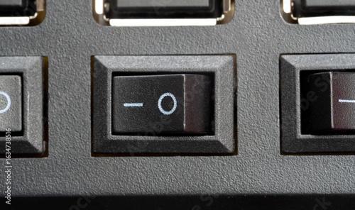 Schilderij op canvas Macro top view of an io rocker power switch in the on position, black plastic bu