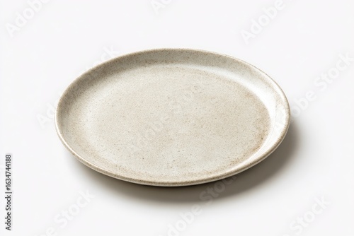 A subtly speckled, off-white ceramic plate sits on a bright white background, showcasing its slightly raised edge and organic texture