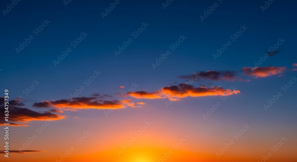 Fototapeta premium Beautiful sunset with orange and blue sky and clouds