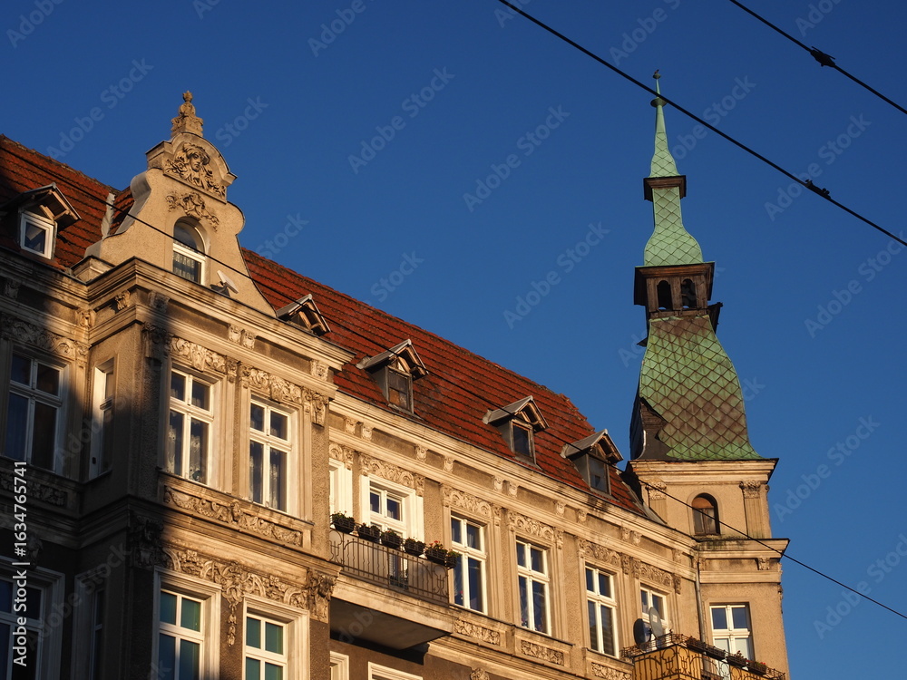 Obraz premium Historic Tenement with Ornate Facade and Spire Tower in Szczecin, Poland