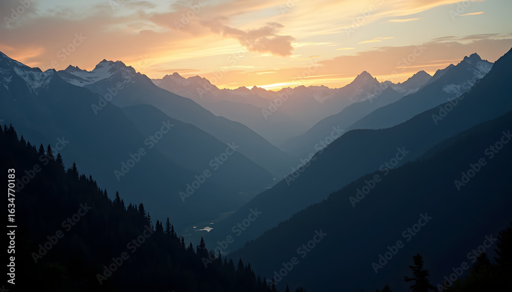 Obraz premium Majestic mountain range at sunset with layers of peaks and golden light