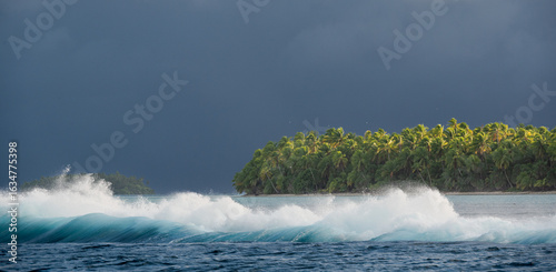 Storm approaching an Island while waves are crashing over the reef barrier