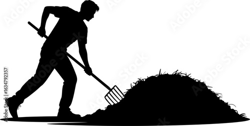 Silhouette of a man working with a pitchfork to move a large pile of organic material.