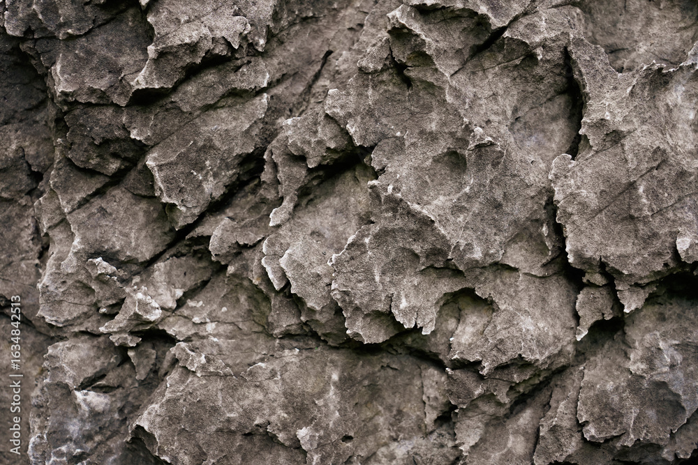 Naklejka premium Layer of grey cave wall surface for abstract background and texture. Template for design, natural patterns, space for work, banner,seamless wallpaper, close up.