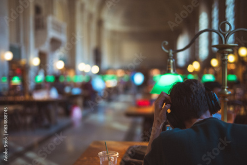 Person frustrated studying with headphones.