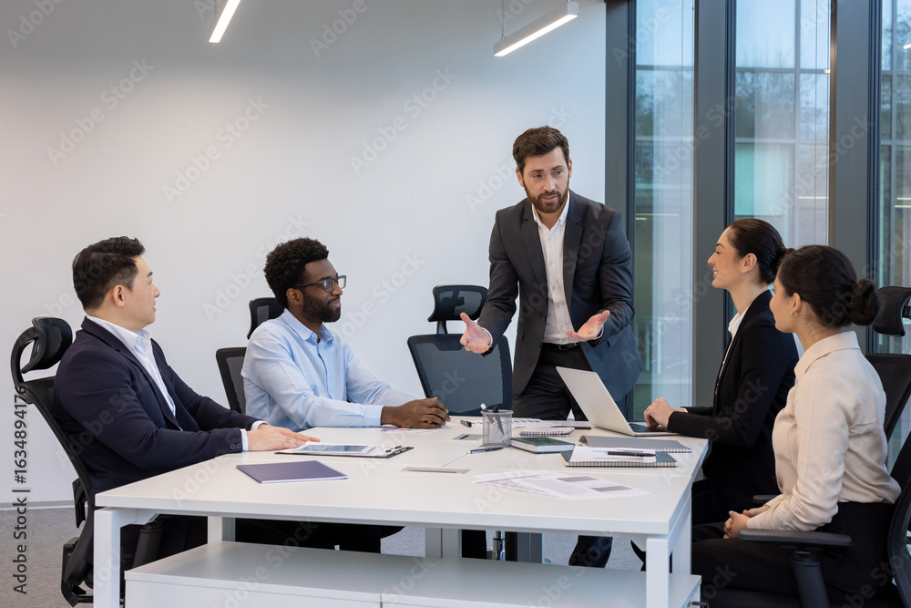 Obraz premium A professional business team collaborating during a presentation in a contemporary office setting, fostering teamwork and strategic discussions.