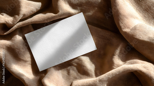 Blank card on draped fabric