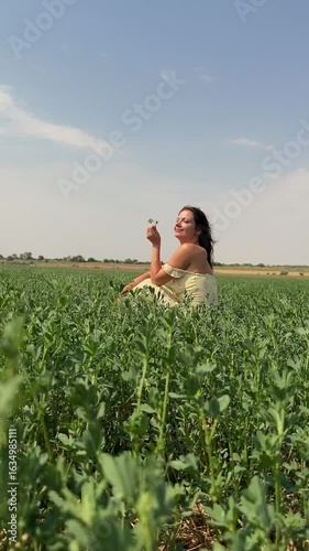 Girl sitting in a field vertical video