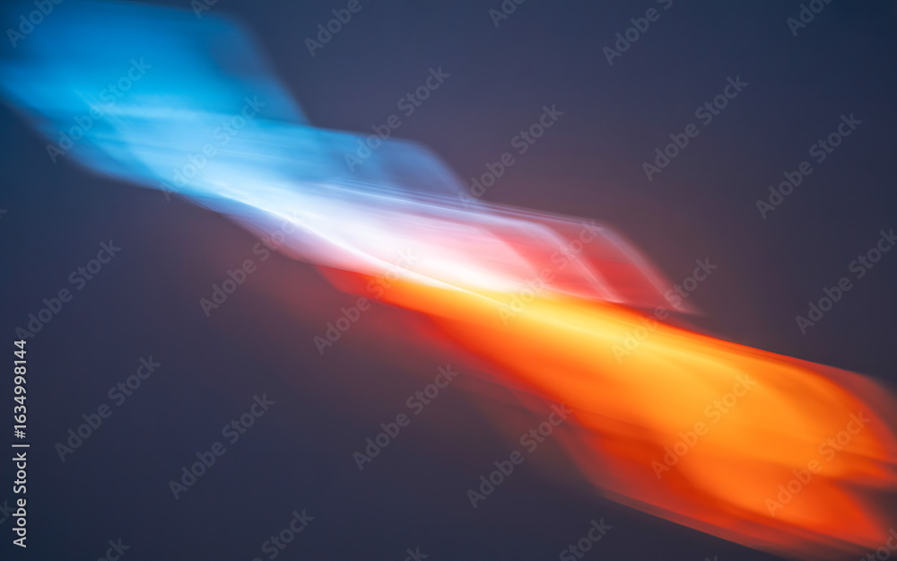 Obraz premium Abstract blue and orange light streaks on dark background