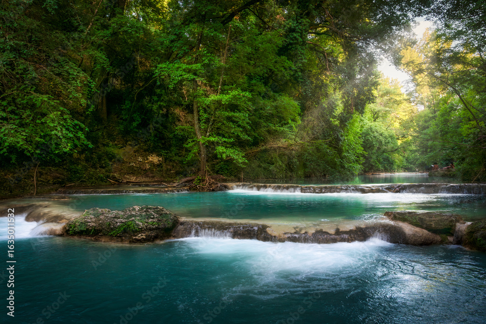 Obraz premium Elsa River and little waterfalls along the Sentierelsa trail. Colle di Val d'Elsa, Tuscany, Italy