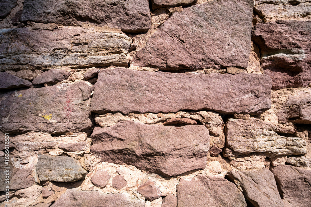 Fototapeta premium Stone wall texture background - grey stone siding with different sized stones