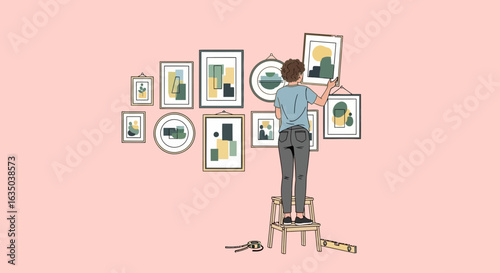 Woman Arranging Gallery Wall With Modern Art Prints At Home