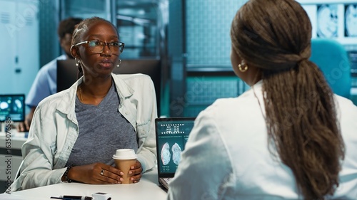 Tablou pe pânză African american girl with bronchitis and a sore throat discuss with medic at the facility, uncomfortable laryngitis inflammation