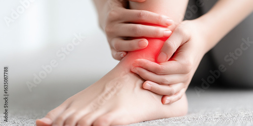 Woman holding ankle with subtle red pain highlight, realistic close-up

