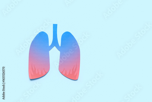 Paper lungs on blue background