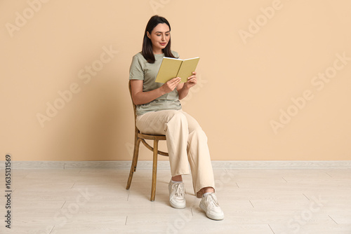 Young woman sitting on chai...