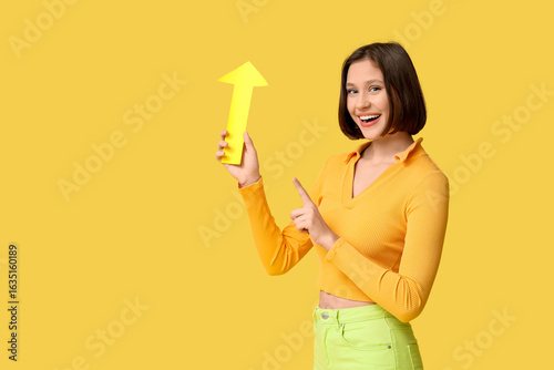 Smiling young woman holding...