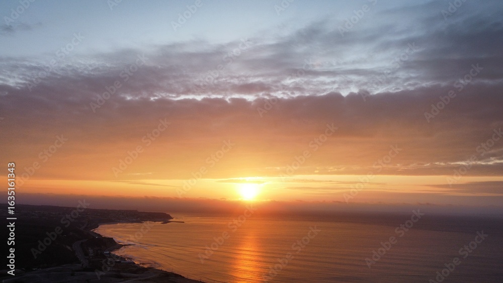 Fototapeta premium Aerial View Of The Golden Hour Over The Sea With Waves And Clouds