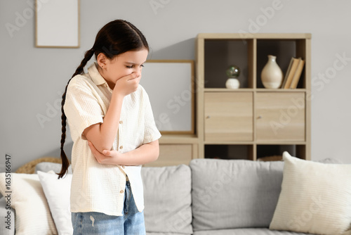 Cute girl feeling unwell at...
