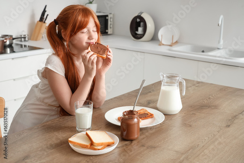 Cute girl eating toasts wit...