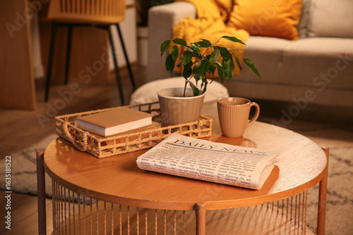 Newspaper with tea cup, boo...