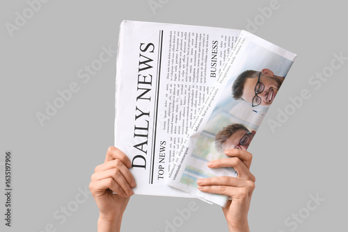 Female hands with newspaper...