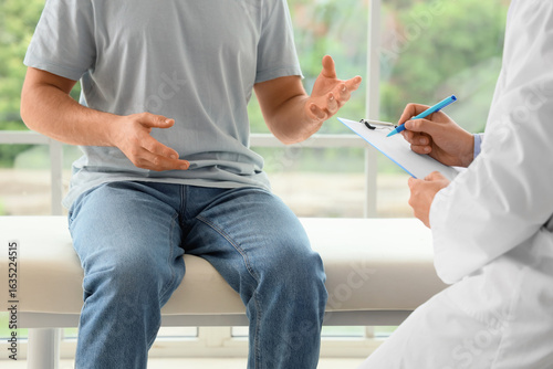 Young man visiting doctor i...