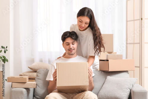 Young couple with parcel bo...