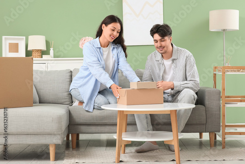 Young couple with parcel bo...