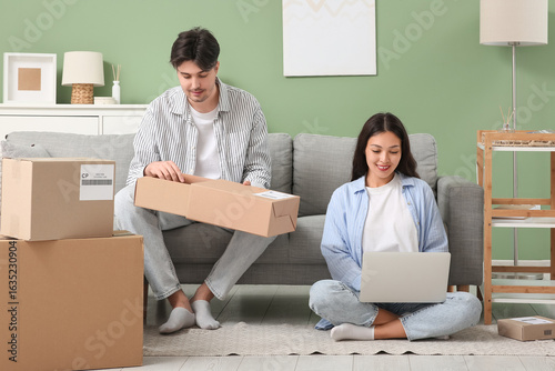 Young couple with parcel bo...