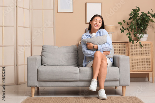 Young Asian woman with pill...