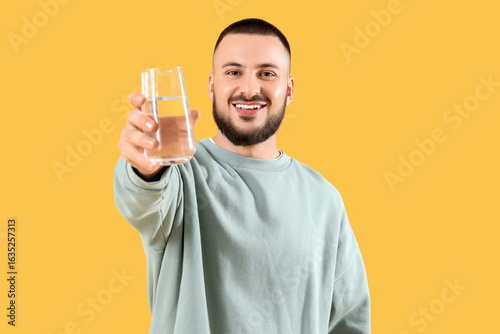Young man with glass of wat...