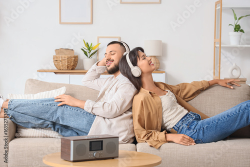 Young couple in headphones ...